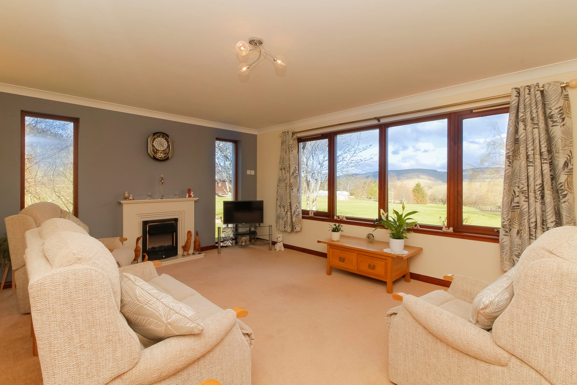 Living room with fireplace and countryside views