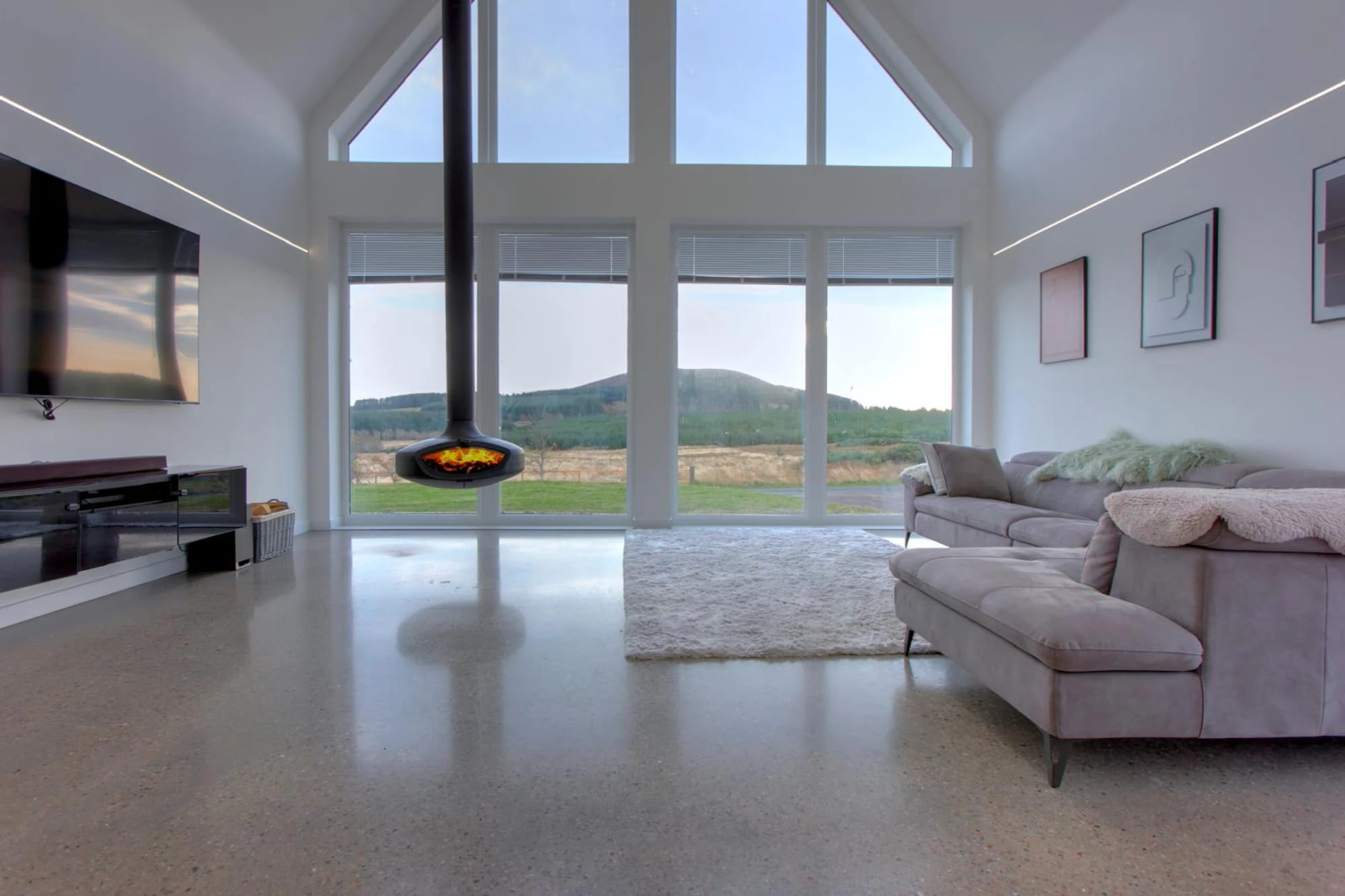 Living room with vaulted ceiling and wood-burning stove