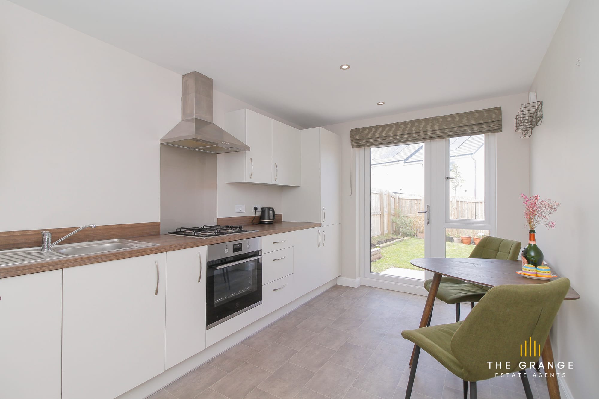 Kitchen with white units and window