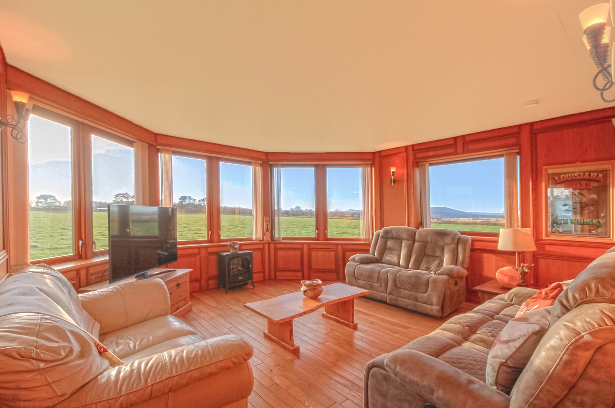 Open-plan living room with vaulted ceiling and countryside views
