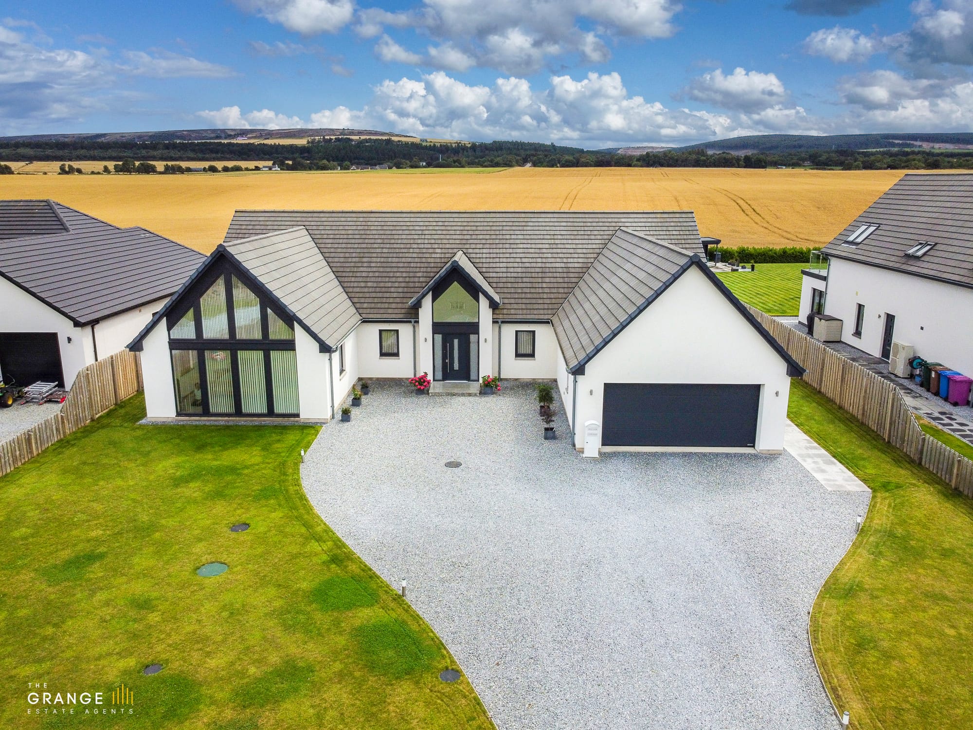 Front elevation of the detached bungalow with double garage and driveway