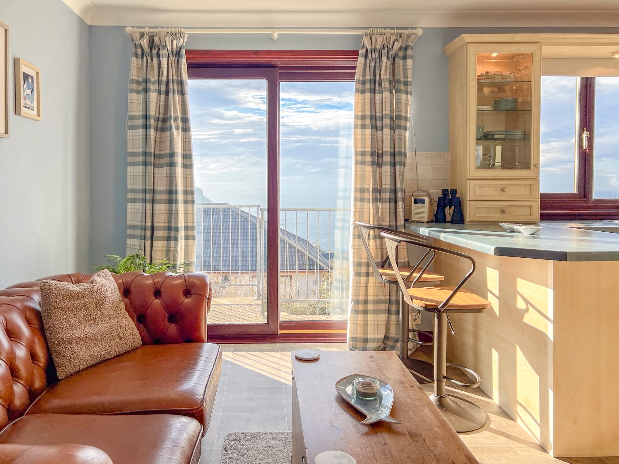 Open-plan kitchen, dining and living area with sea views